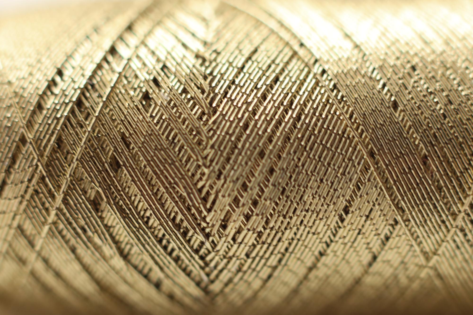 Close-up of premium embroidered linen with gold thread